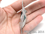 Lord of the Rings ELESSAR Brooch, Sterling Silver or White Bronze, USA-The Elessar, also known as the Stone of Eärendil, is a silver eagle brooch set with a great green stone given to Aragorn by Galadriel as the fellowship departed Lothlórien in JRR Tolkien's The Fellowship of the Ring. This officially licensed replica is individually handcrafted in fine white bronze or sterling silver. -