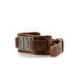 -The NC (Non-Compliant) mark is used to humiliate and isolate those who defy patriarchal overlords but many consider it a battle scar, a symbol of feminist strength and power. Genuine leather wrist strap cuff bracelet with antiqued bronze NC tag. Official Image Comics Bitch Planet accessory. Handmade in USA, New w/COA-