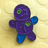 -Voodoo Doll soft enamel pin with rubber pin bac. Teal and purple on black metal base. Measures approximately 1inch. Shipped from the USA. Cute funny goth gothic horror witchcraft halloween pinback badge bag backpack hat lapel accessory pin-