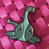 -Cute, soft enamel Lochness Monster pin with rubber pin back from the Cryptid Collection. Measures approximately 1inch. Shipped from the USA. © LaBranche Designs, LLC kawaii cryptozoology mythology urban legend pinback badge brooch jewelry bag backpack hat accessory-