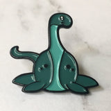 -Cute, soft enamel Lochness Monster pin with rubber pin back from the Cryptid Collection. Measures approximately 1inch. Shipped from the USA. © LaBranche Designs, LLC kawaii cryptozoology mythology urban legend pinback badge brooch jewelry bag backpack hat accessory-