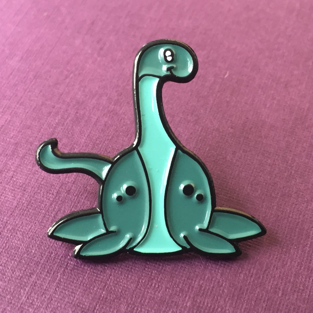 -Cute, soft enamel Lochness Monster pin with rubber pin back from the Cryptid Collection. Measures approximately 1inch. Shipped from the USA. © LaBranche Designs, LLC kawaii cryptozoology mythology urban legend pinback badge brooch jewelry bag backpack hat accessory-