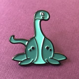-Cute, soft enamel Lochness Monster pin with rubber pin back from the Cryptid Collection. Measures approximately 1inch. Shipped from the USA. © LaBranche Designs, LLC kawaii cryptozoology mythology urban legend pinback badge brooch jewelry bag backpack hat accessory-