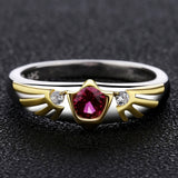 Legend of Zelda Ocarina of Time Sterling Goron Ruby Hylian Shield Ring-High quality ring inspired by the second of the spiritual stones, Goron's Ruby and the Hylian Shield. Handcrafted in .925 sterling silver with 18K gold plated accents and set with CZ crystals.Brand new in jeweler's ring box. Not to be confused with some of the cheap metal alloy knock-offs. Free Shipping Worldwide.-