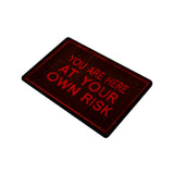 You Are Here At Your Own Risk Doormat, Unique Dark Warning Welcome Mat-High quality 23.6 x 15.7in (60x40cm) doormat / floor mat. Professionally printed, durable & colorfast polyester top, non-slip. Indoor / outdoor use. Free Shipping Worldwide. You Are Here At Your Own Risk - red and black dark warning door mat. Creepy caution message. Halloween, haunted house or gothic home decor gift. -