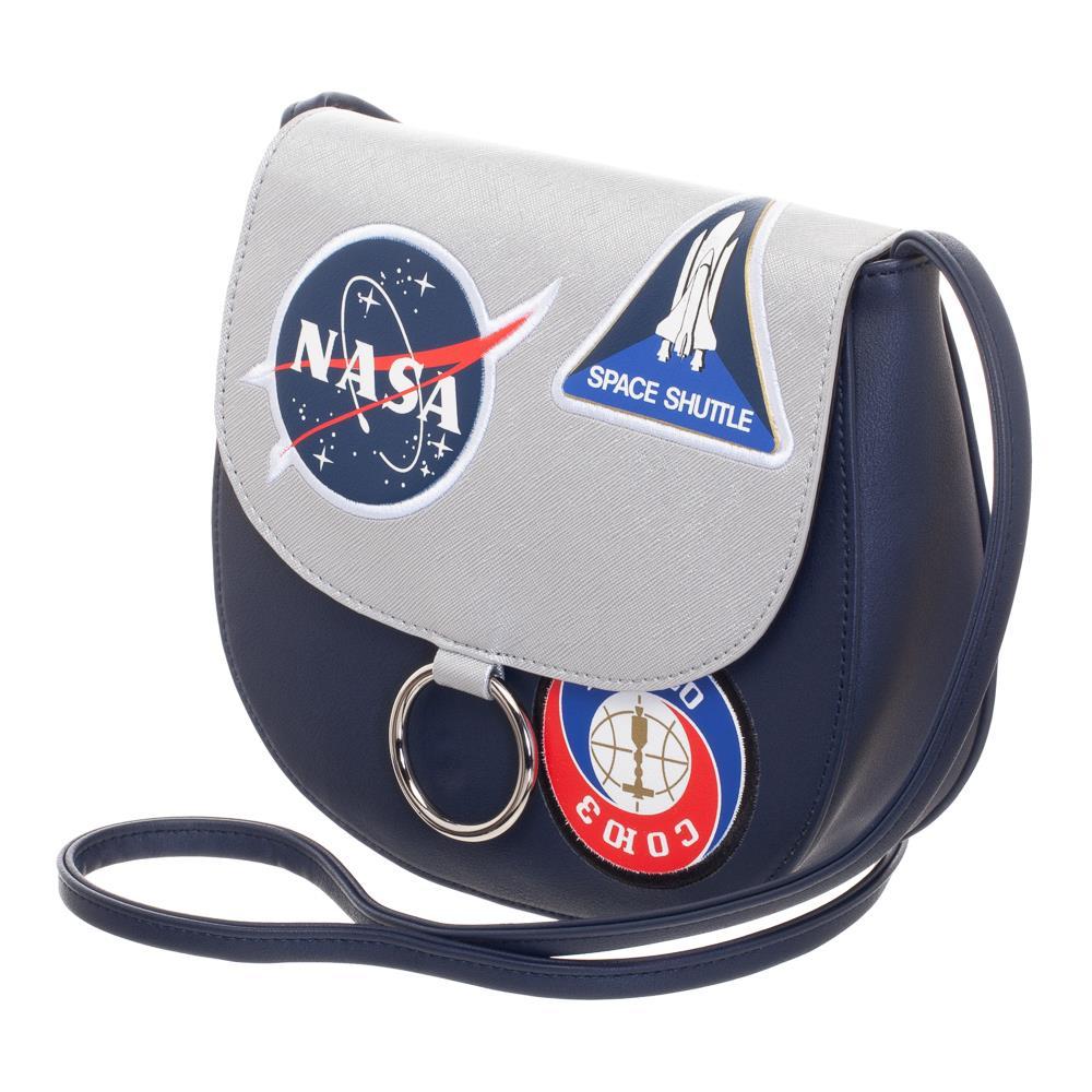 NASA Shuttle Team Crossbody Bag, Officially Licensed, US Seller-Show your support for NASA's continuing mission with this officially licensed crossbody bag. A retro futuristic spin on the traditional 'saddle bag' design. The bag is a deep navy with a secure gray flap closure featuring NASA insignia, shuttle and station patches. Interior of the flap is neatly finished with a star pattern. Officially licensed NASA product. Typically ships in 2-3 business days from within the USA.-Navy-OS-