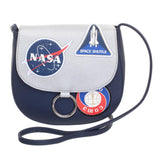 NASA Shuttle Team Crossbody Bag, Officially Licensed, US Seller-Show your support for NASA's continuing mission with this officially licensed crossbody bag. A retro futuristic spin on the traditional 'saddle bag' design. The bag is a deep navy with a secure gray flap closure featuring NASA insignia, shuttle and station patches. Interior of the flap is neatly finished with a star pattern. Officially licensed NASA product. Typically ships in 2-3 business days from within the USA.-Navy-OS-