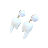 Unique Tooth Shaped Dangle Earrings, White Resin Weird Abstract Modern-A pair of unique white resin teeth shaped dangle fashion earrings. Each tooth measures approximately 2.5cm x 1.5cm on ~1cm matching round stud earring.Free Shipping Worldwide. This item ships promptly from abroad and typically arrives in about 2-3 weeks.-