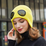 -Fashionable thick (160g) plush lined, knit polyester beanie with bomber cap style ear flaps and built in tinted goggles. Orange, black, white, green, purple, blue or yellow modern European style winter hat. A fun and functional fashion accessory for travel and outdoor activity on cold days. Free Shipping Worldwide. -Yellow-