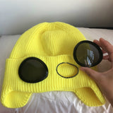 -Fashionable thick (160g) plush lined, knit polyester beanie with bomber cap style ear flaps and built in tinted goggles. Orange, black, white, green, purple, blue or yellow modern European style winter hat. A fun and functional fashion accessory for travel and outdoor activity on cold days. Free Shipping Worldwide. -