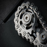 -Metal bicycle-style chain and sprocket fidget toy. Durable, high quality construction. Measures approximately 3cm x 6cm / 1.2 x 2.4 inches. Free shipping from abroad. Typically arrives in about 2-3 weeks.

Unique different spinning link chain and gear anxiety diffusing perpetual motion machine toy-