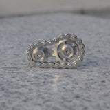 -Metal bicycle-style chain and sprocket fidget toy. Durable, high quality construction. Measures approximately 3cm x 6cm / 1.2 x 2.4 inches. Free shipping from abroad. Typically arrives in about 2-3 weeks.

Unique different spinning link chain and gear anxiety diffusing perpetual motion machine toy-